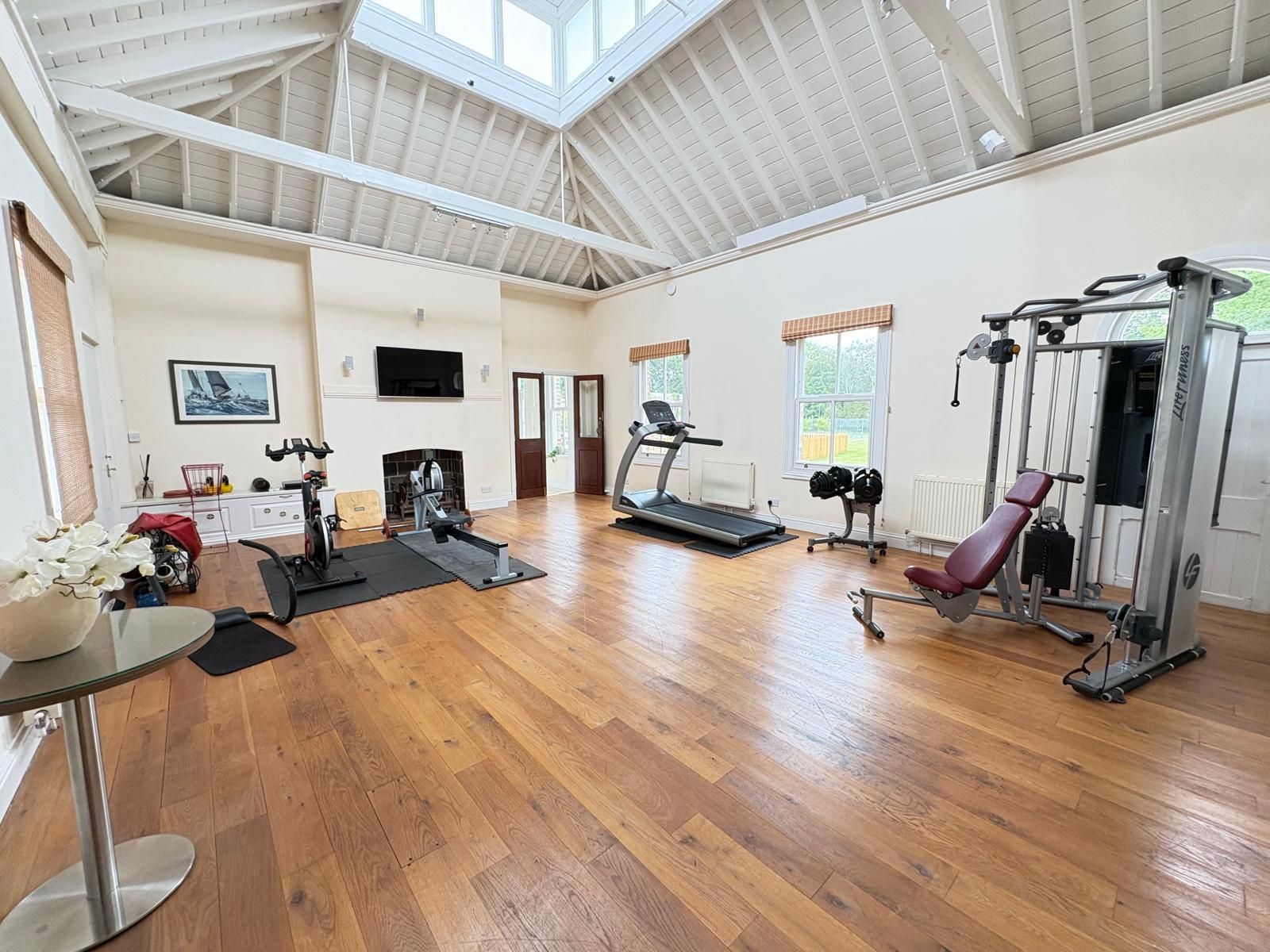 Gym with vaulted ceiling and natural light